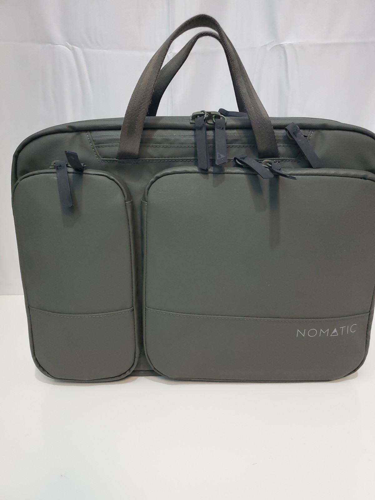 Nomatic 11L laptop Bag, Expands to 13.5L, Fits 16" Laptops- Olive MSRP:  $169.99