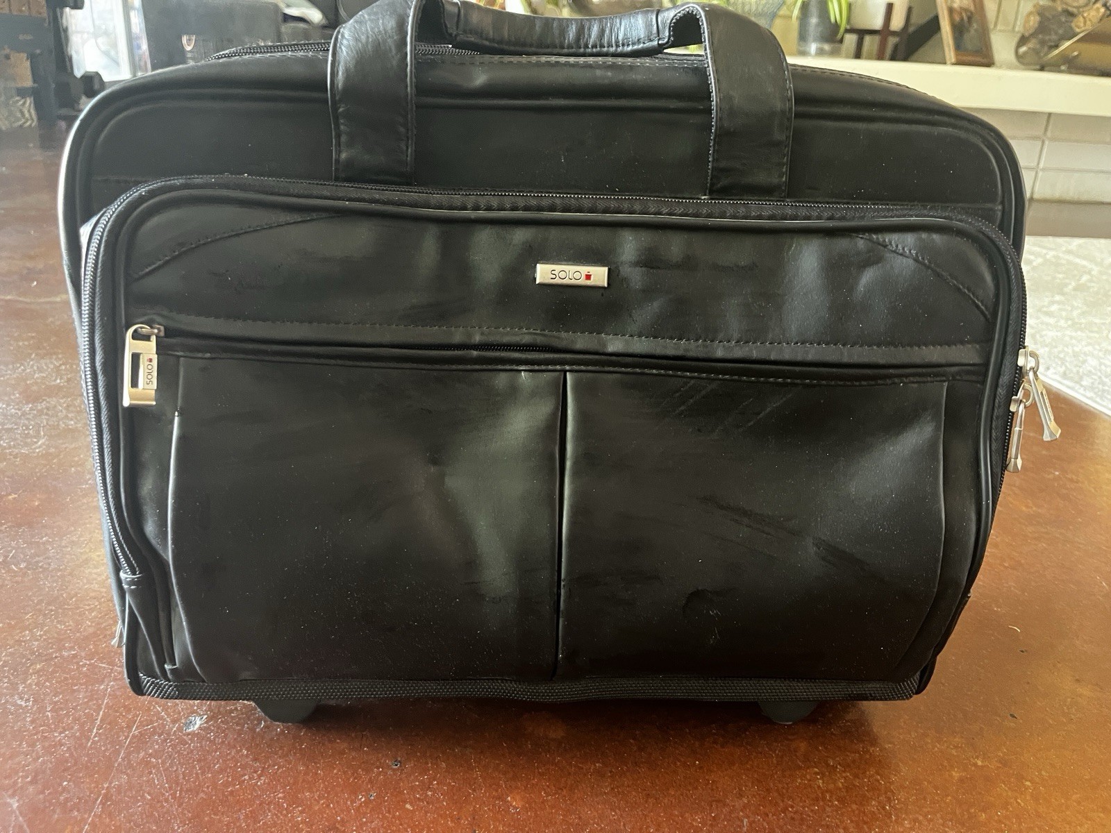 Solo Black Rolling Leather Laptop Bag with Adjustable Shoulder Strap and Handle