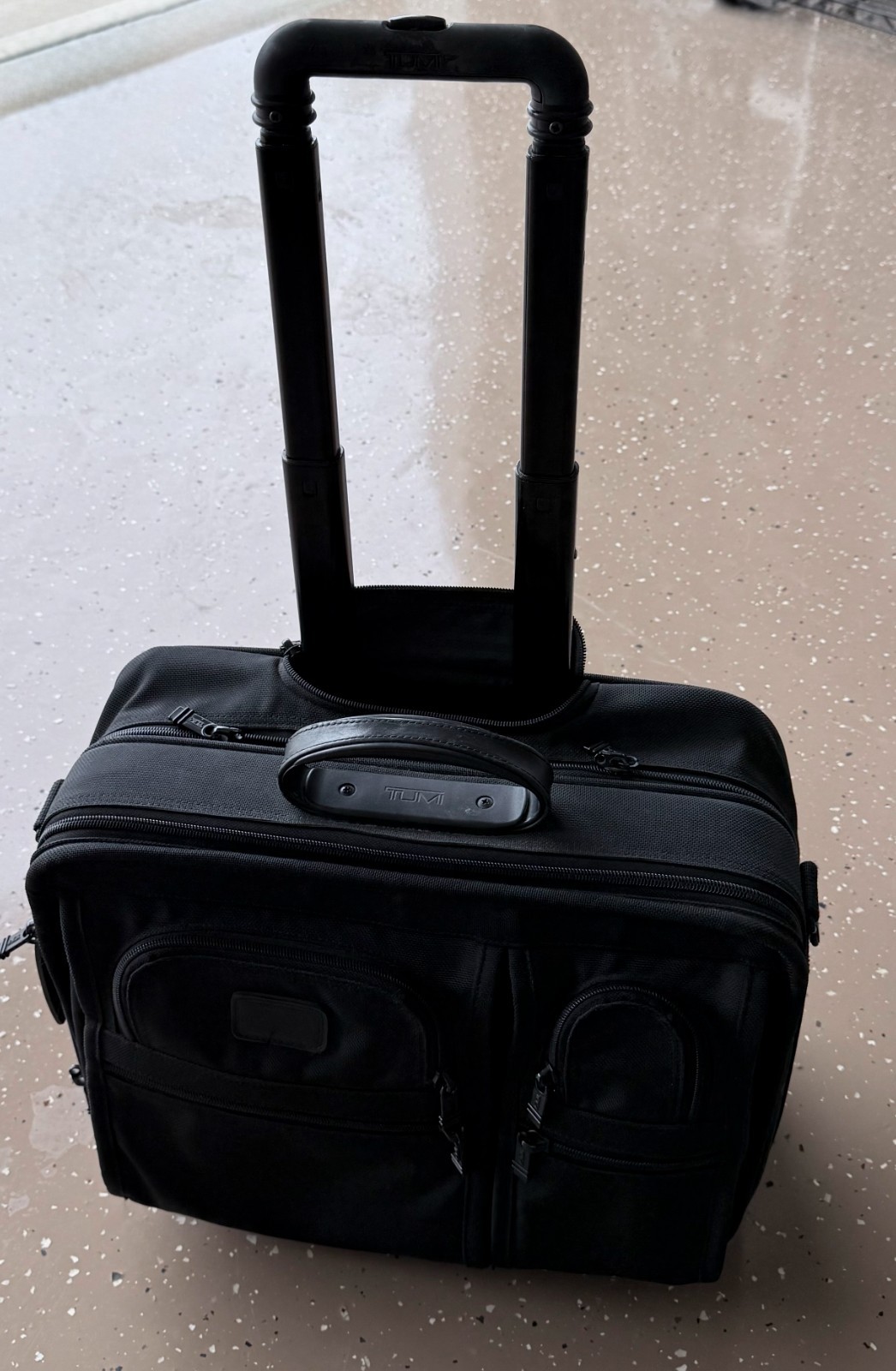 Tumi - Rolling laptop brief with telescoping handle, ballistic nylon.
