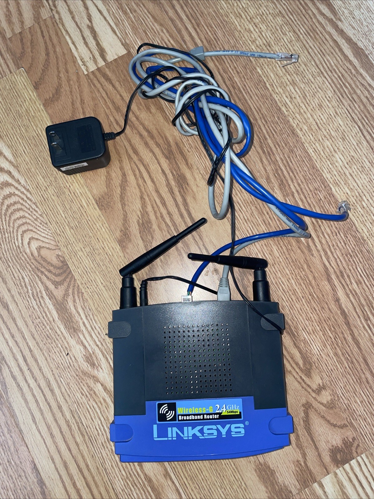 Linksys WRK54G 54 Mbps 4-Port 10/100 Wireless G Router Power Source And Cables