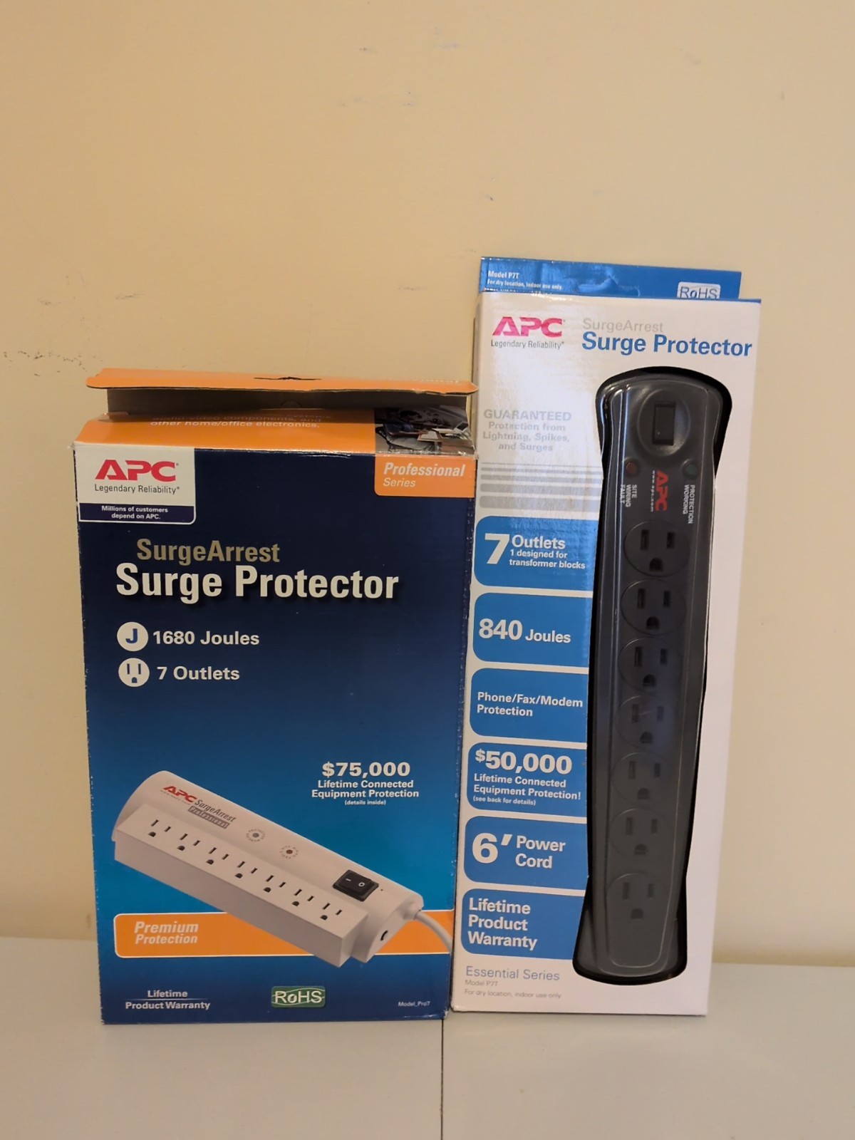 2 APC Surge Protector. Both 7 Outlet. One 840 Joules. The Other 1680 Surge