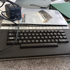 Atari 1200 XL home computer with original owners guide and power supply power on picture